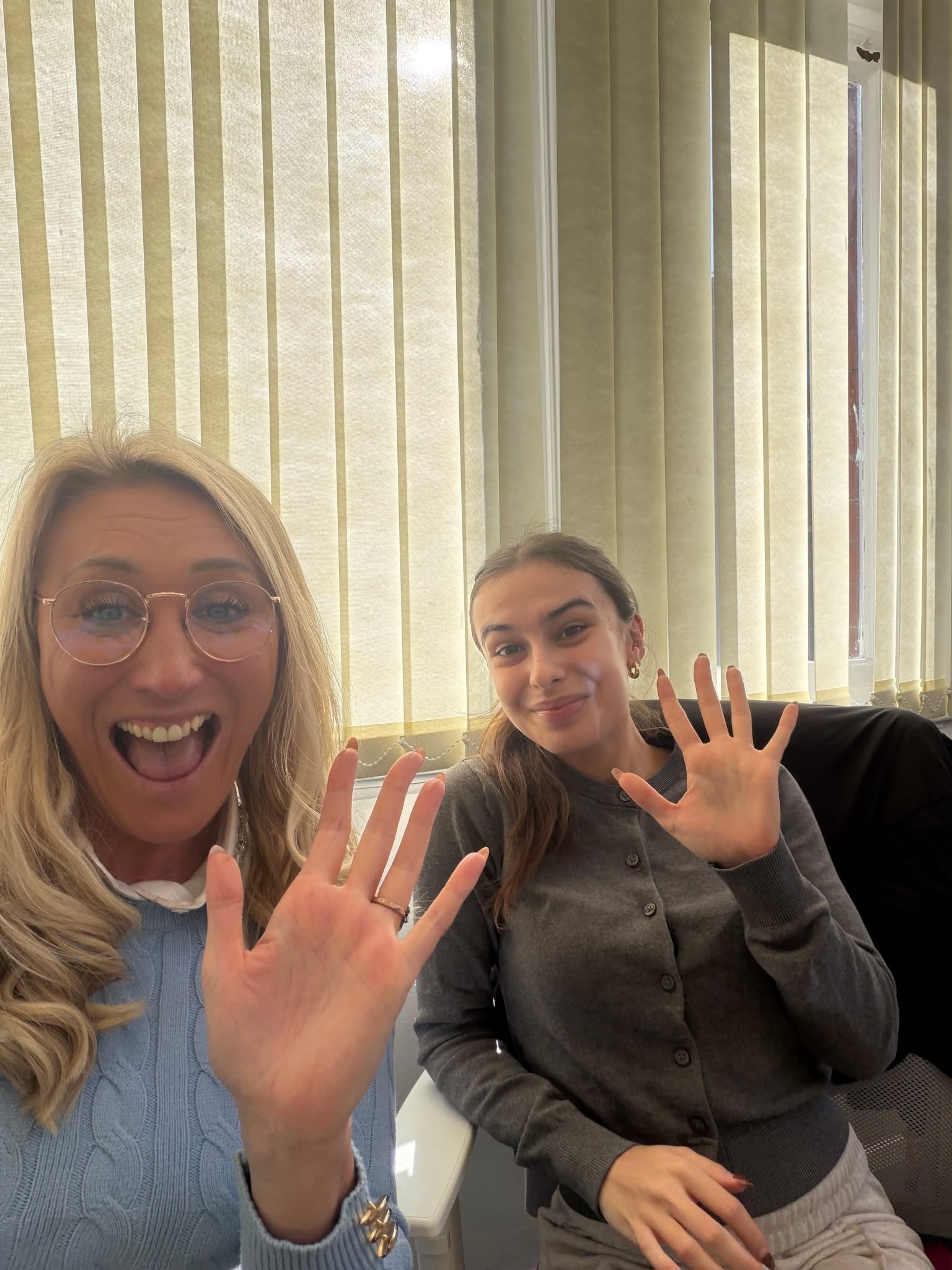 Two people waving during a training day