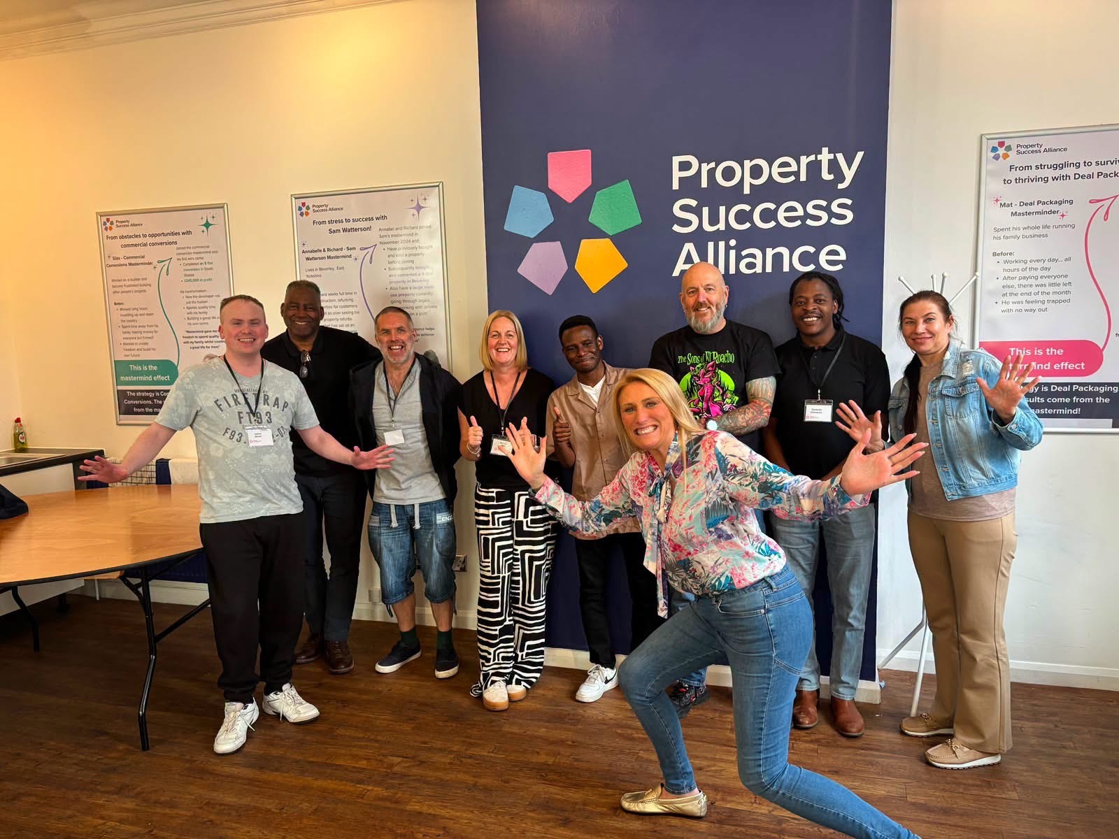 Group celebrating together by the branded wall