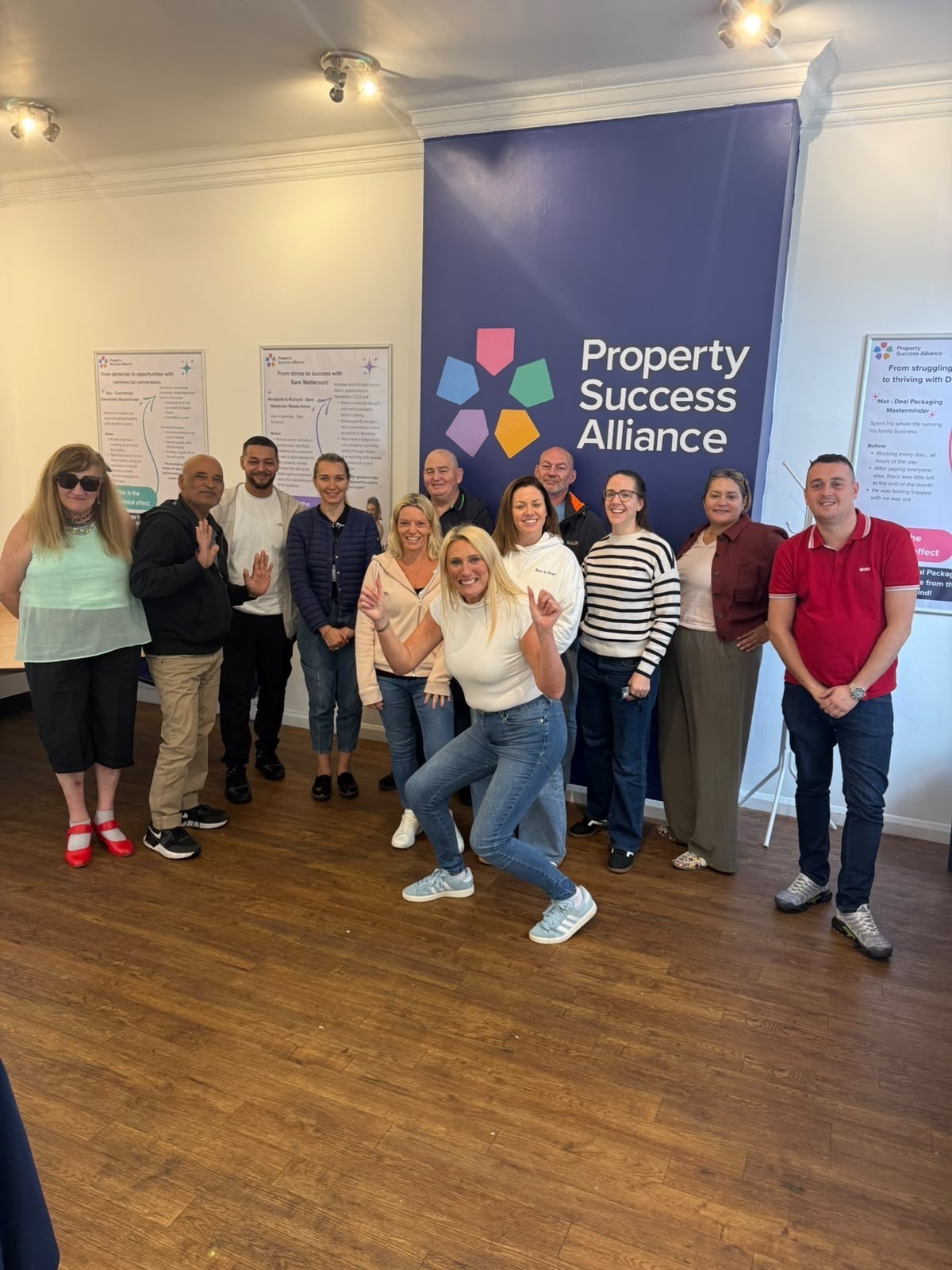 Katy and delegates together in front of the Property Success Alliance wall