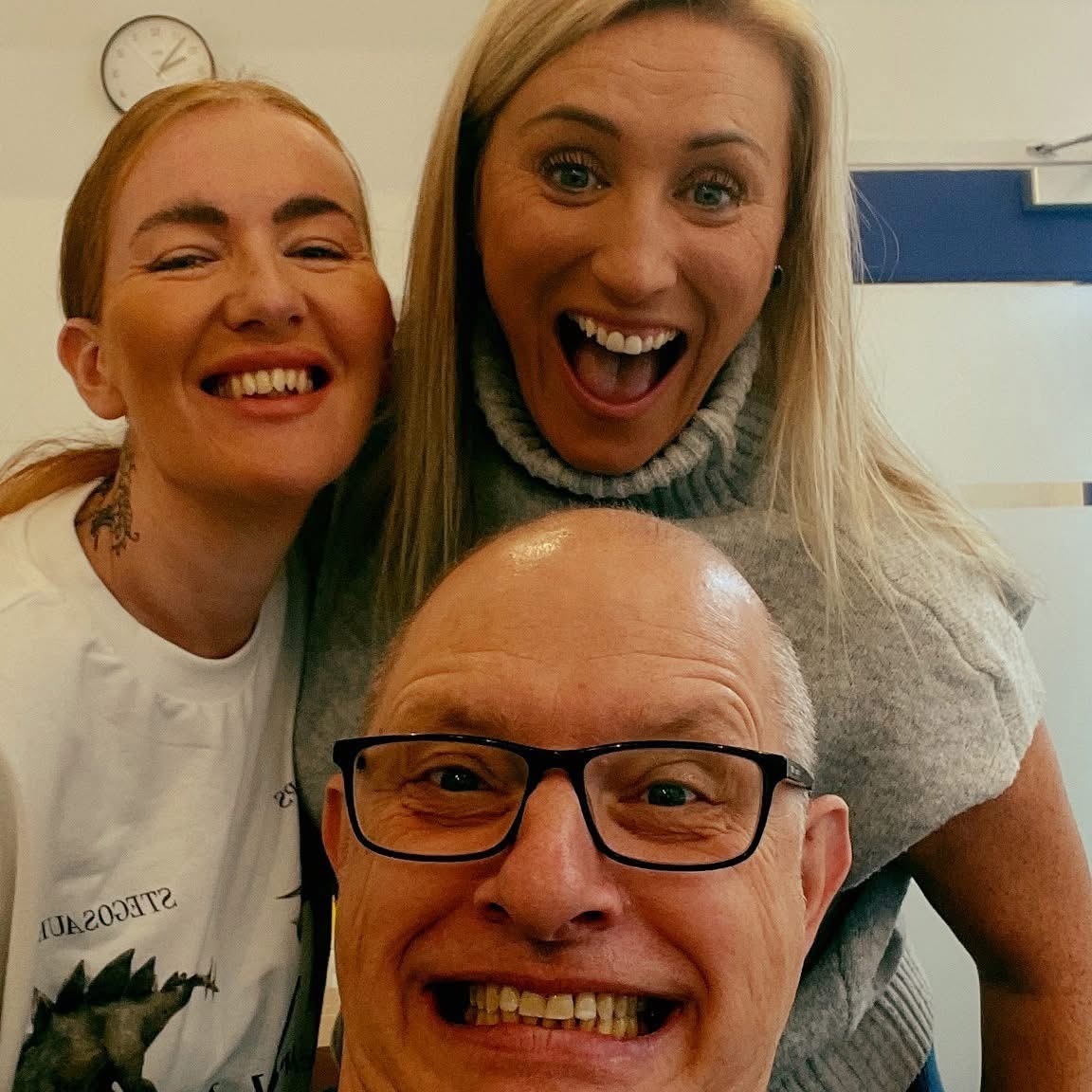 Three people smiling together