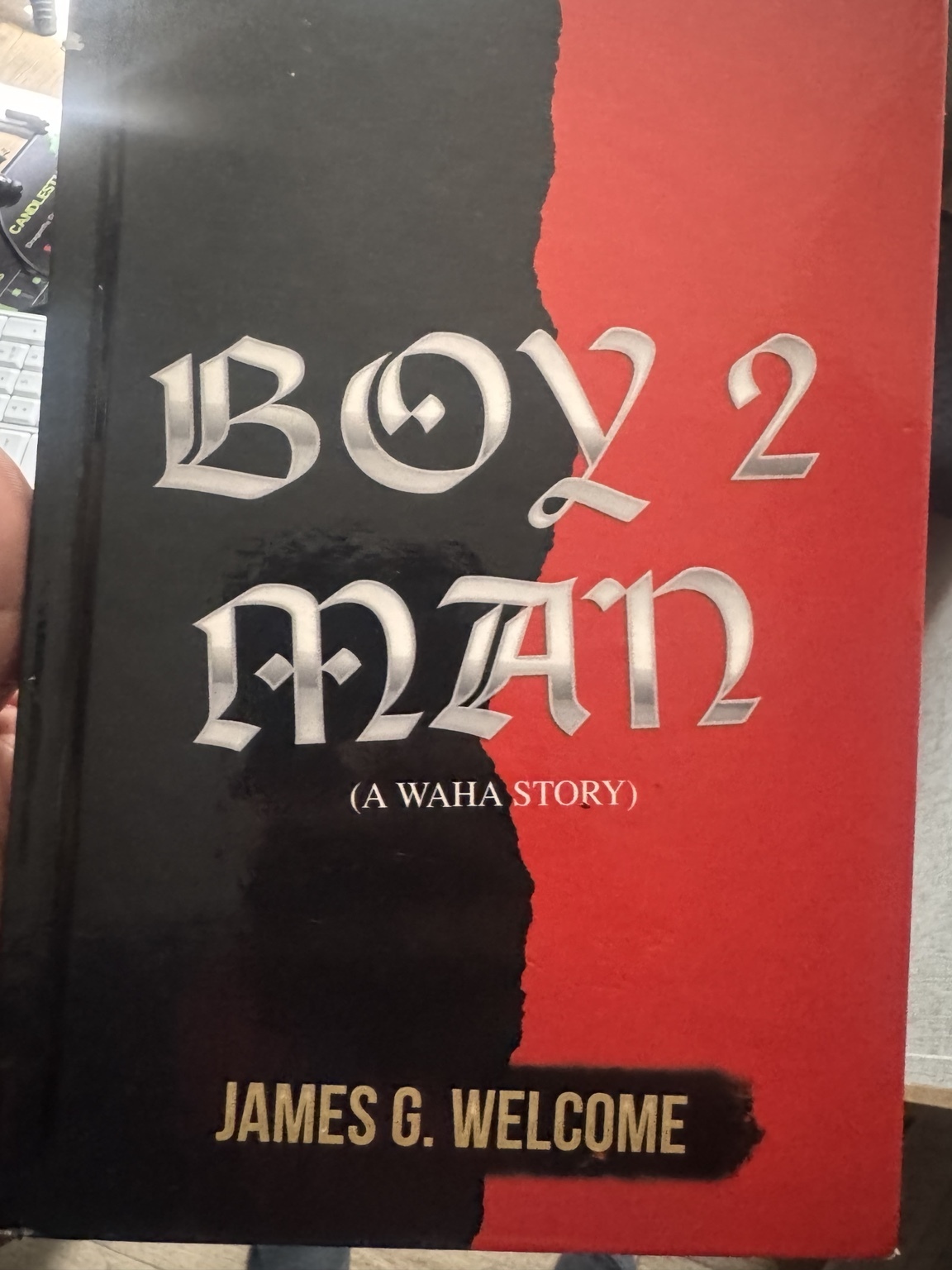 Original black-and-red cover of Boy 2 Man: A Waha Story by James G. Welcome